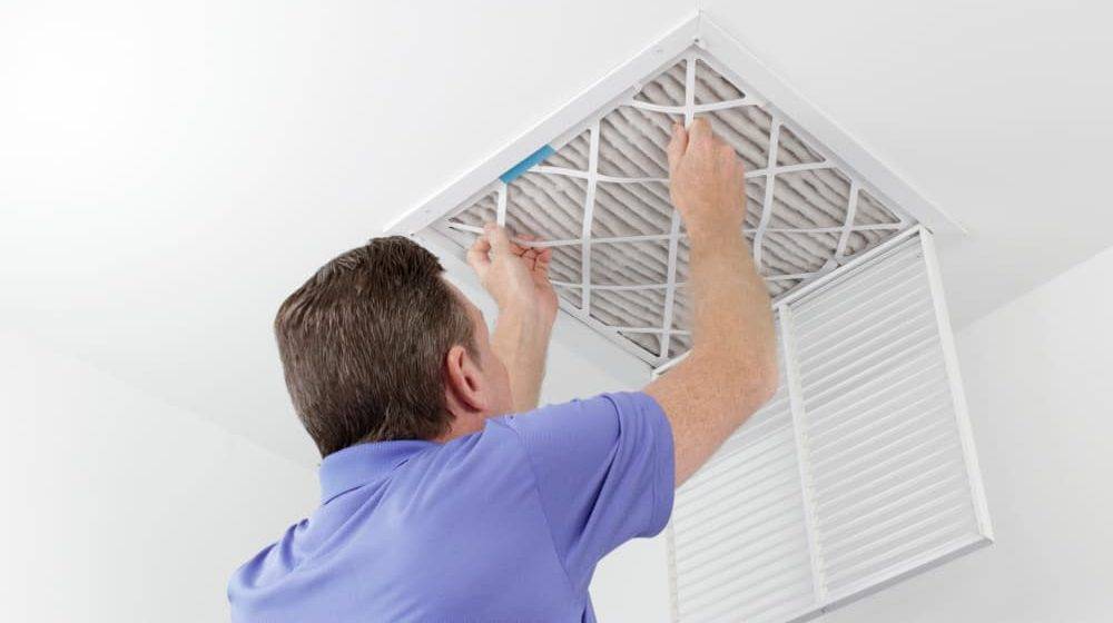 Person Removing Ceiling Air Filter 1 e1620949005611